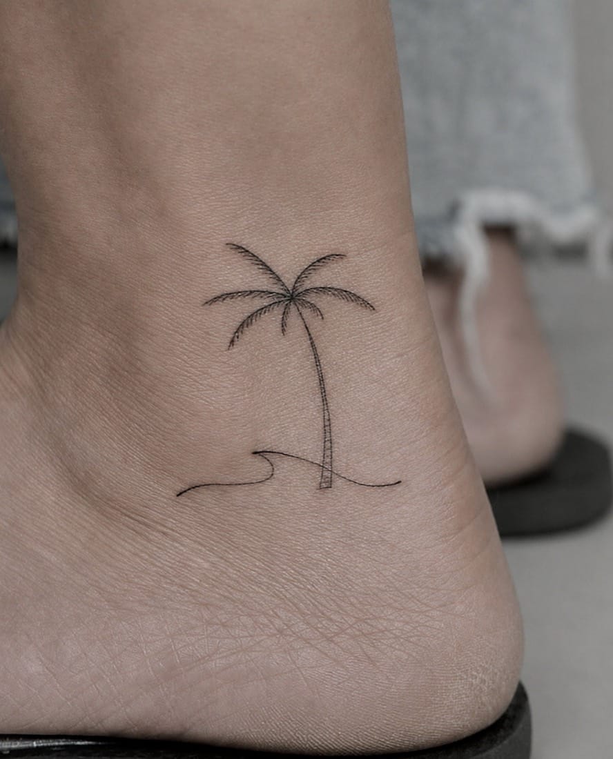 Fine line palm tree and wave tattoo by a London Fine Line Tattoo Academy student