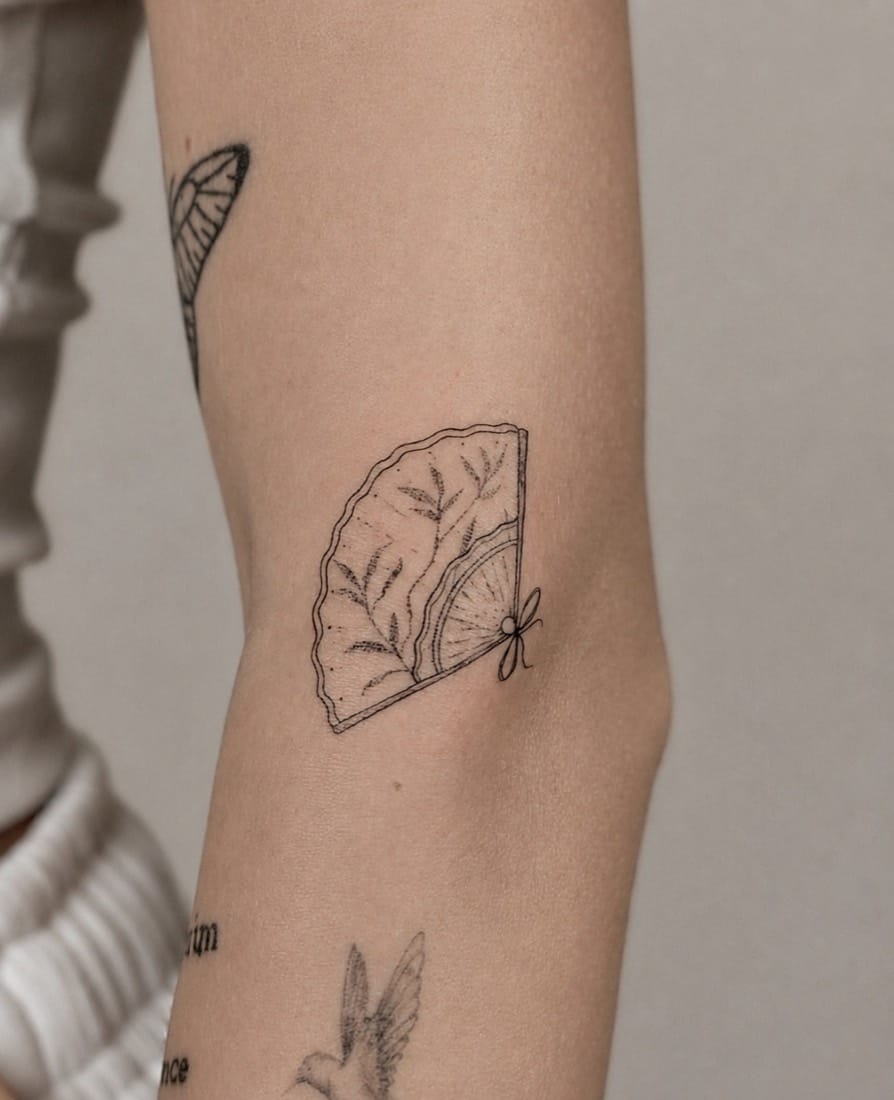 Fine line folding fan with foliage tattoo by a London Fine Line Tattoo Academy student